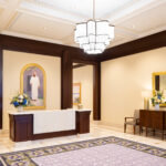 The entry and reception desk of the Saratoga Springs Utah Temple features a painting of Jesus. Paintings of the Savior are hanging throughout the temple to remind guests, this is His holy house. (Intellectual Reserve, Inc.)