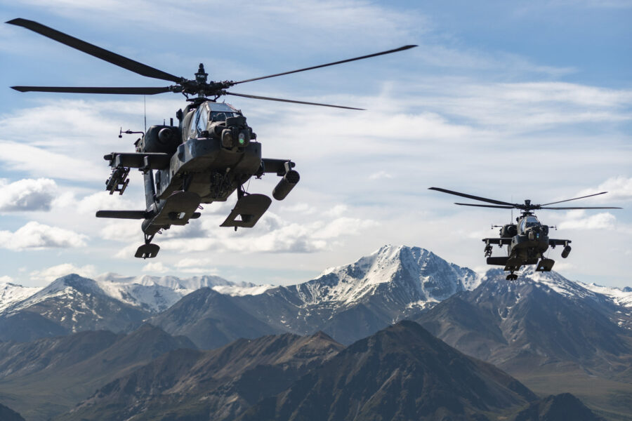 In this photo released by the U.S. Army, AH-64D Apache Longbow attack helicopters from the 1st Atta...