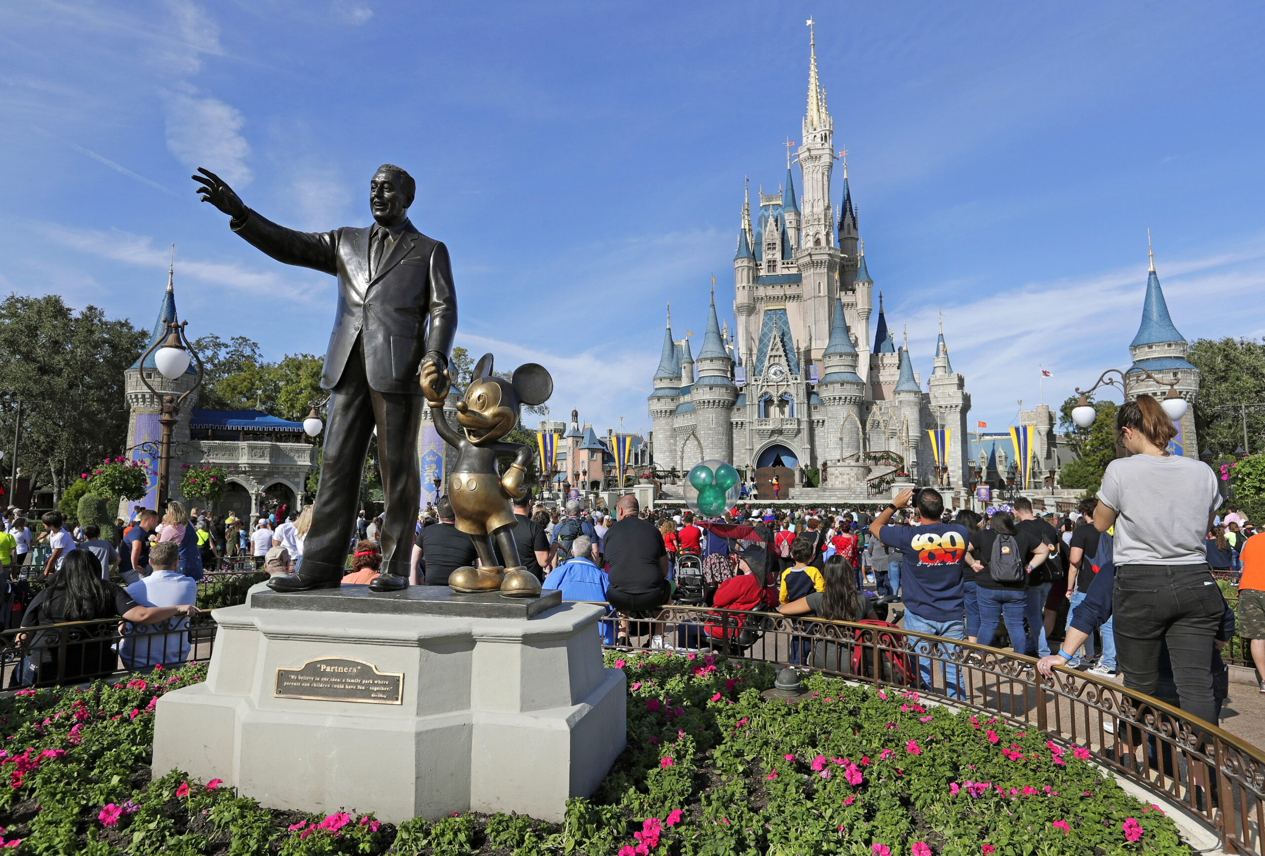 FILE - A statue of Walt Disney and Micky Mouse stands in front of the Cinderella Castle at the Magi...
