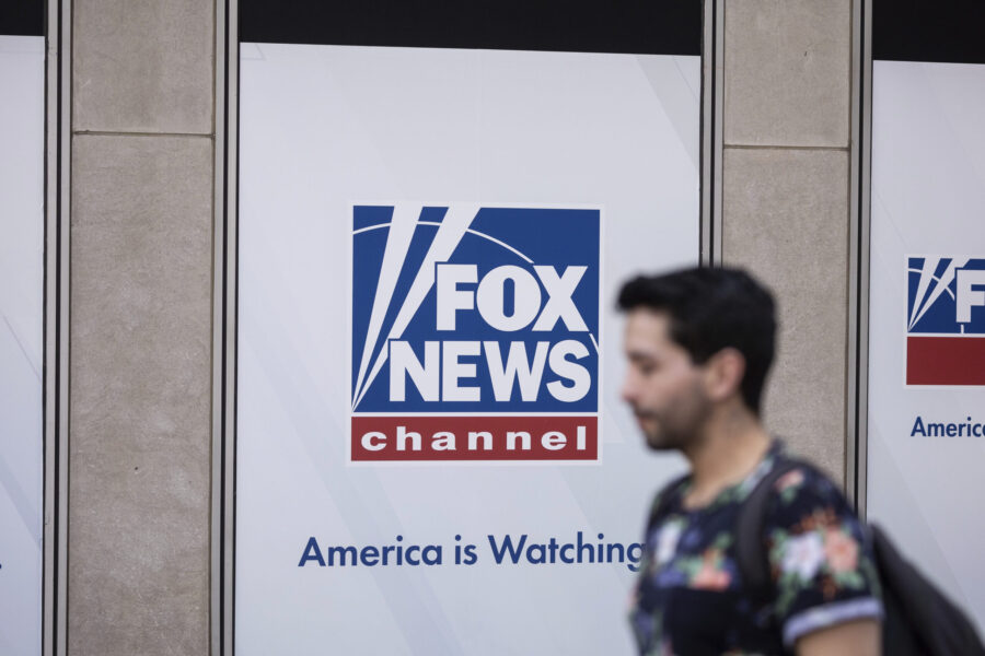 FILE - A person walks past the Fox News Headquarters in New York, April. 12, 2023. Dominion Voting ...