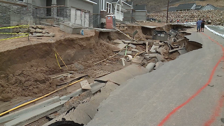 The sinkhole made after the flooding in a Kaysville, Utah neighborhood. (KSLTV)...