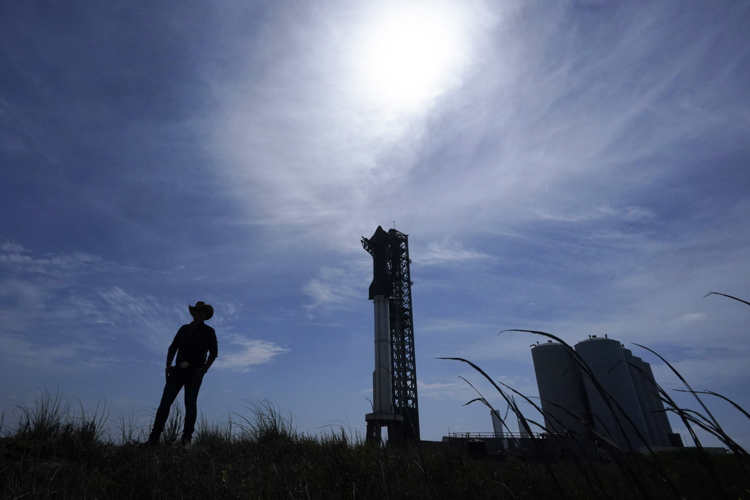A man walks past the site where SpaceX's Starship, the world's biggest and most powerful rocket, si...