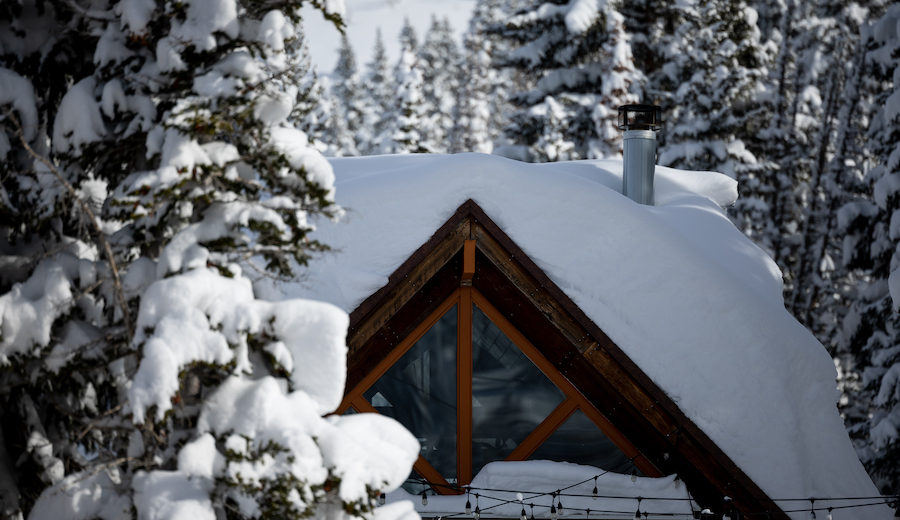 FILE: A home is covered in deep snow in the town of Brighton in Big Cottonwood Canyon on Wednesday,...