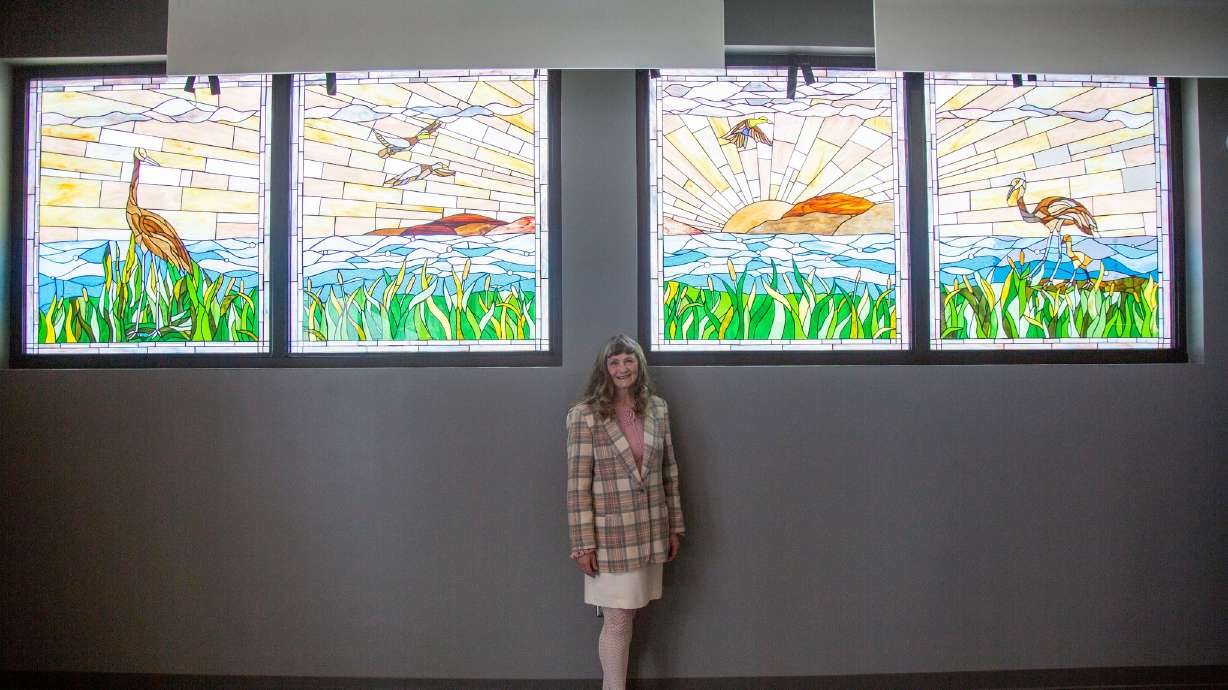 Provo artist Jeanne Gomm stands in front of her Utah Lake stained glass mural at the unveiling of t...
