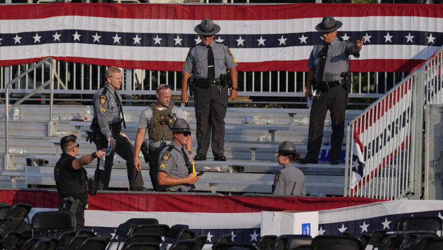 Law enforcement officers gather at the campaign rally site for Republican presidential candidate fo...